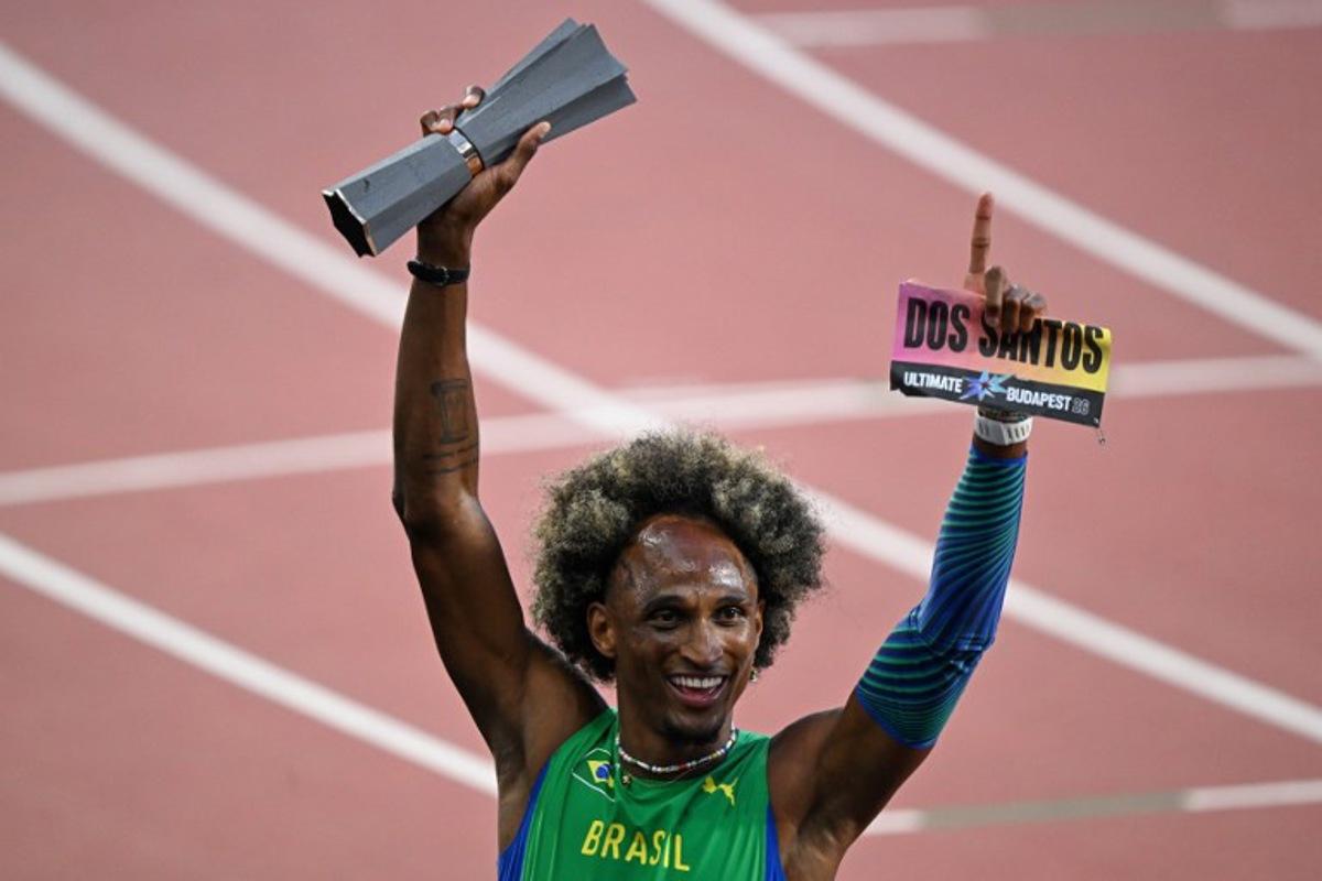 Brazil's Alison Dos Santos celebrates with his trophy after winning men's 400m hurdles final during the World Athletics Ultimate Championship at the Gyula Zsivotzky National Athletics Centre, in Budapest on September 13, 2026.  Attila KISBENEDEK / AFP