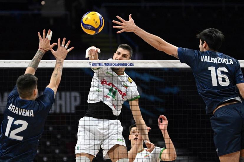 Bulgaria's Aleks Grozdanov (C) spikes the ball against Chile's Noe Aravena (L) and Vicente Valenzuela during their match at the Volleyball Men's World championship in Manila on September 17, 2025.   Ted ALJIBE / AFP
