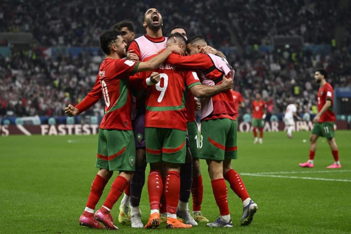 Morocco's forward #9 Abderrazzaq Hamed Allah celebrates with his teammates after scoring his team's seccond goal during the FIFA Arab Cup 2025 final football match between Jordan and Morocco at the Lusail Stadium  Stadium, in Lusail on December 18, 2025.  Mahmud HAMS / AFP