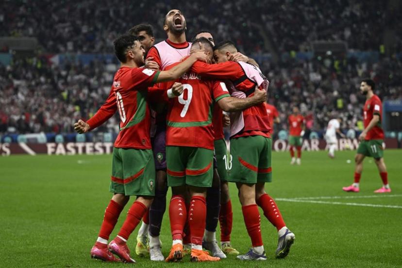 Morocco's forward #9 Abderrazzaq Hamed Allah celebrates with his teammates after scoring his team's seccond goal during the FIFA Arab Cup 2025 final football match between Jordan and Morocco at the Lusail Stadium  Stadium, in Lusail on December 18, 2025.  Mahmud HAMS / AFP