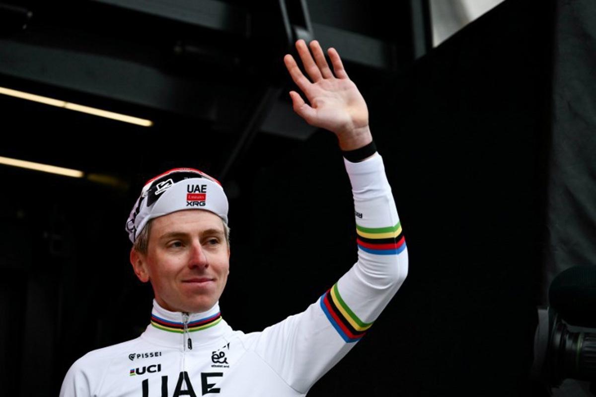 UAE Team Emirates's Slovenian Tadej Pogacar waves as he celebrates on the podium after winning the 20th one-day classic 'Strade Bianche' (White Roads) men's cycling race between Siena and Siena in Tuscany on March 7, 2026.  Marco BERTORELLO / AFP
