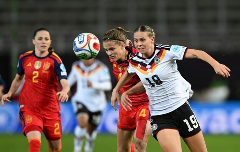 Germany's midfielder #19 Klara Buehl (R) and Spain's defender #04 Irene Paredes vie for the ball during UEFA Women's Nations League first leg final football match between Germany and Spain in Kaiserslautern, western Germany on November 28, 2025.  THOMAS KIENZLE / AFP