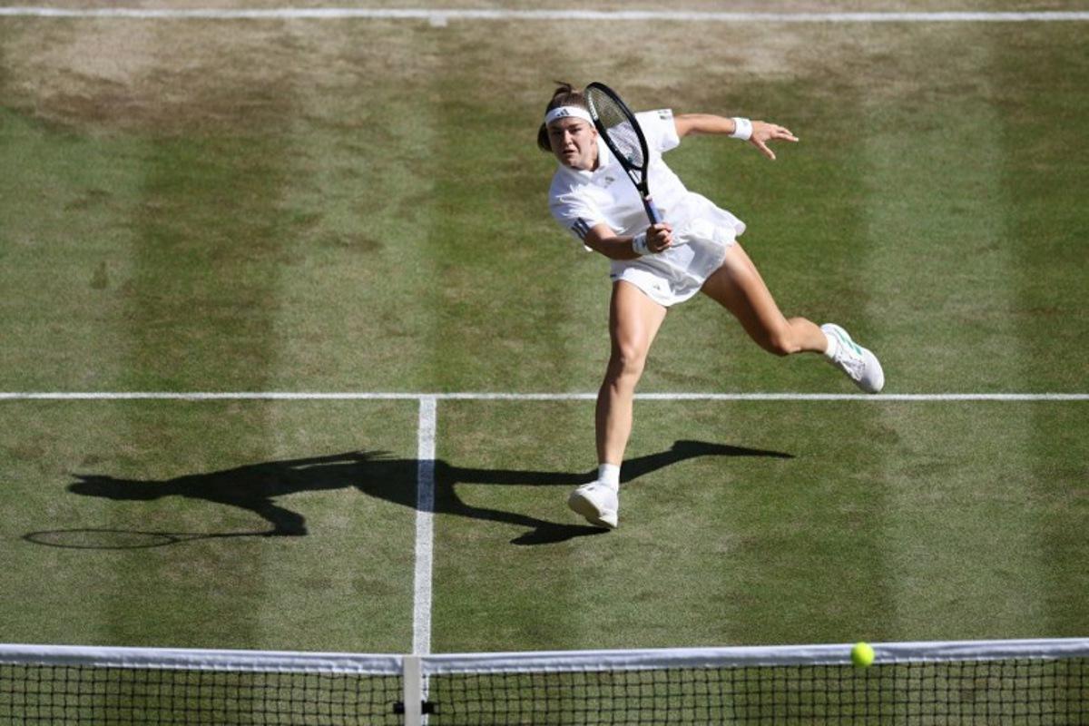 Czech Republic's Karolina Muchova returns against Japan's Naomi Osaka during their women's singles quarter-final tennis match on the ninth day of the 2026 Wimbledon Championships at The All England Lawn Tennis and Croquet Club in Wimbledon, southwest London, on July 7, 2026.  Henry NICHOLLS / AFP
