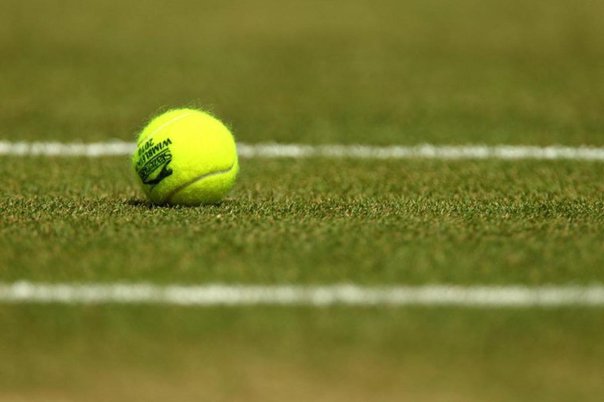 A tennisball is pictured courside during play between Czech player Tomas Berdych and Spanish player Rafael Nadal during the men's singles grand final of the Wimbledon Tennis Championships at the All England Tennis Club, in southwest London on July 4,  2010.     AFP PHOTO / GLYN KIRK  GLYN KIRK / AFP