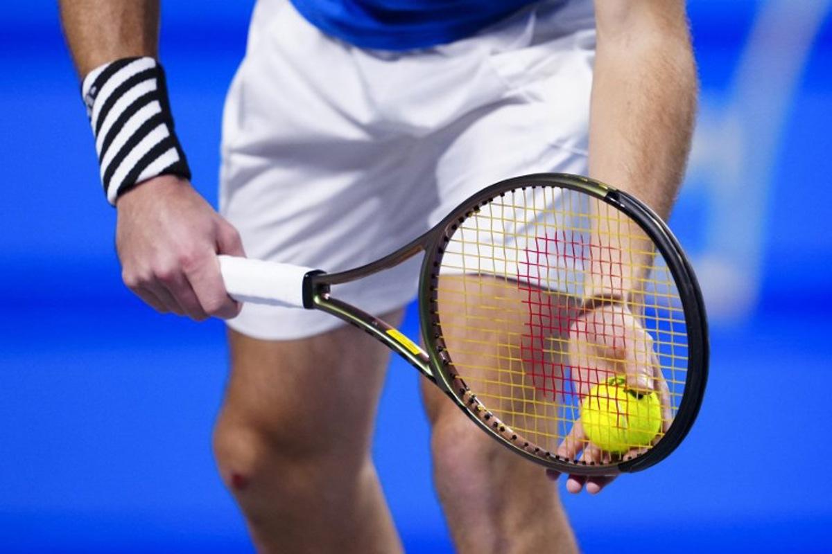 A tennis players holds racquet and ball to play a serve to his opponent during a match of the Erste Bank Open tennis tournament in Vienna on October 26, 2023.  Eva MANHART / APA / AFP