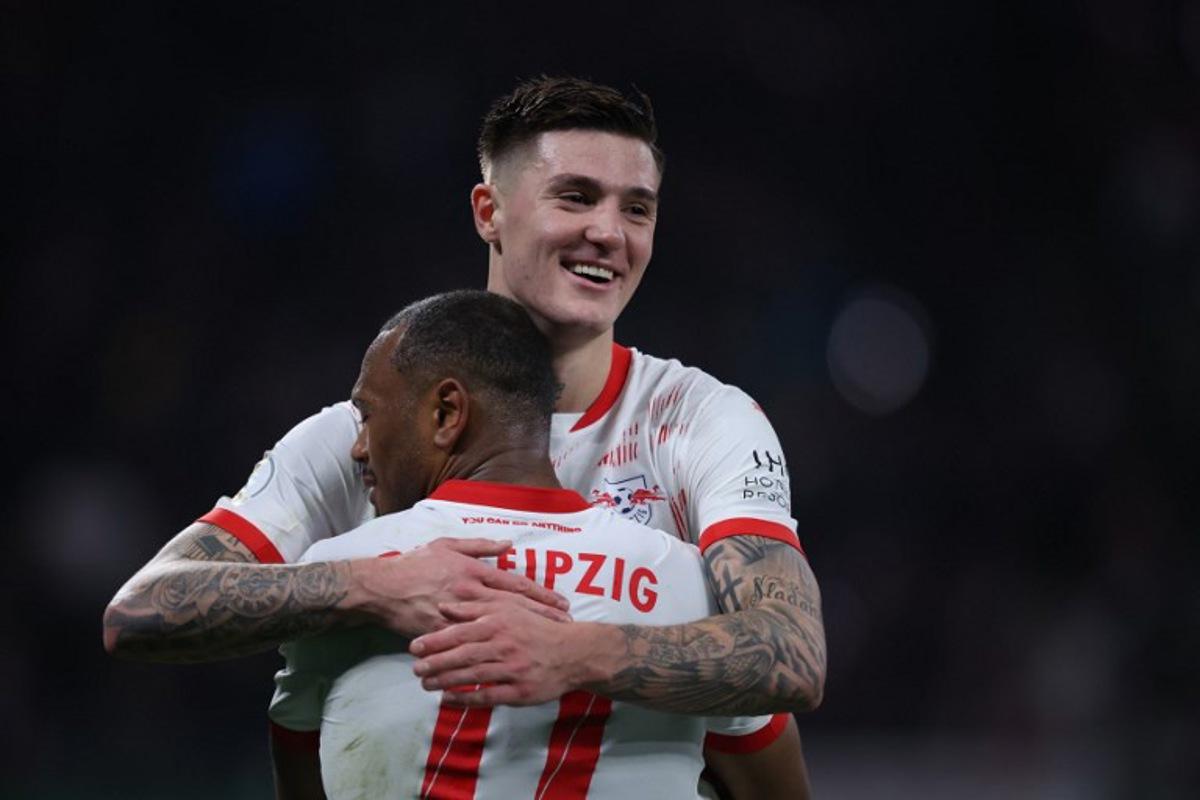 Leipzig's Belgian forward #11 Lois Openda (Front) and Leipzig's Slovenian forward #30 Benjamin Sesko celebrate after the German Cup (DFB Pokal) quarter final football match between RB Leipzig and VfL Wolfsburg in Leipzig, eastern Germany, on February 26, 2025.   Ronny HARTMANN / AFP