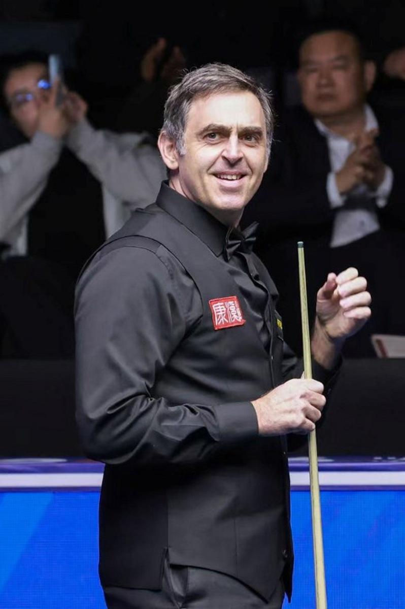 Britain's Ronnie O'Sullivan reacts after making professional snooker history with the highest ever break of 153 during his match against Ryan Day of Wales at the Snooker World Open in Yushan, in China's Jiangxi province on March 20, 2026.  CN-STR / AFP