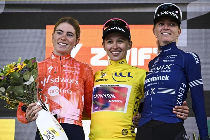 (From L) Stage winner and second placed Team SD Worx - Protime's Dutch rider Demi Vollering, Overalll leader and first placed Canyon//SRAM Racing team's Polish rider Katarzyna Niewiadoma wearing the overall leader's yellow jersey and third placed Fenix-Deceuninck team's Dutch rider Pauliena Rooijakkers celebrate on the podium after competing in the 8th and last stage of the third edition of the Women's Tour de France cycling race, a 149.9 km between Le Grand Bornand and the Alpe d'Huez, in L'Alpe d'Huez, south-eastern France, on August 18, 2024.  JULIEN DE ROSA / AFP