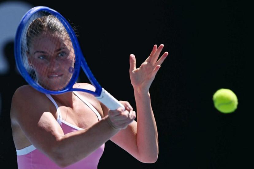 Ukraine's Marta Kostyuk hits a return against France's Elsa Jacquemot during their women's singles match on day one of the Australian Open tennis tournament in Melbourne on January 18, 2026.  WILLIAM WEST / AFP