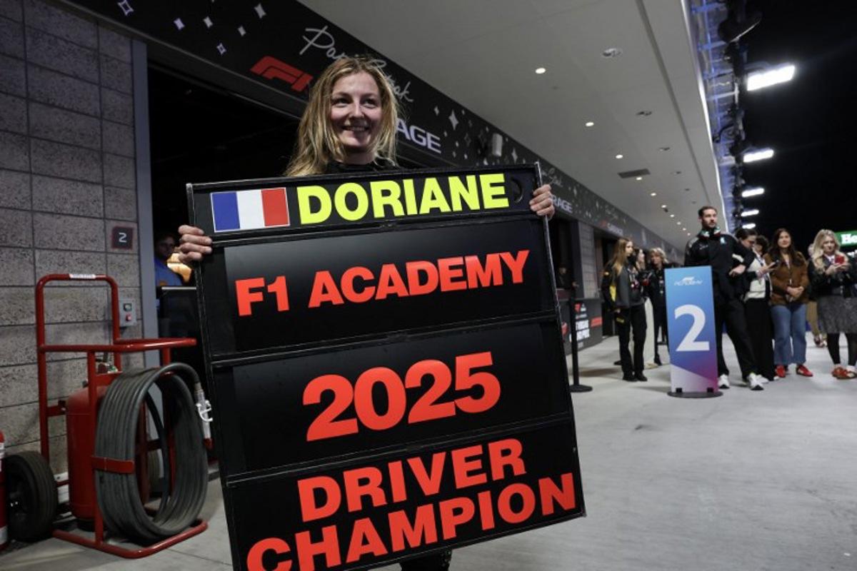 French driver Doriane Pin celebrates her 2025 F1 Academy drivers' championship victory after the F1 Academy race at the Las Vegas Strip Circuit in Las Vegas, Nevada, on November 22, 2025.  Patrick T. Fallon / AFP