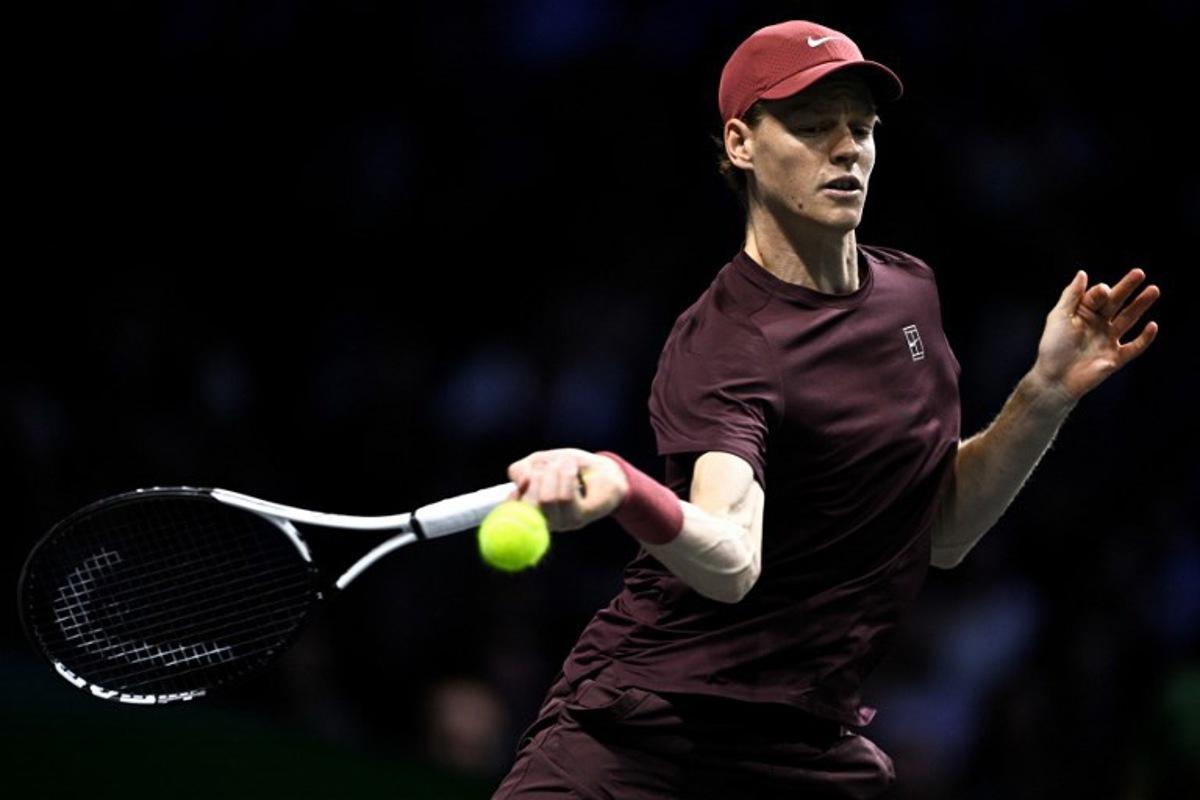 Italy's Jannik Sinner plays a forehand return to Germany's Alexander Zverev during their men's singles semi-final match on day six of the Paris ATP Masters 1000 tennis tournament at the Paris La Défense Arena in Nanterre, on the outskirts of Paris, on November 1, 2025.  JULIEN DE ROSA / AFP