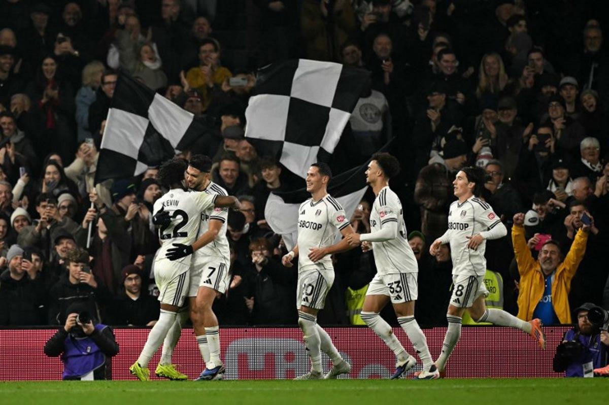 Fulham's Mexican striker #07 Raul Jimenez (2L) celebrates scoring the opening goal during the English Premier League football match between Fulham and Nottingham Forest at Craven Cottage in London on December 22, 2025.  Ben STANSALL / AFP