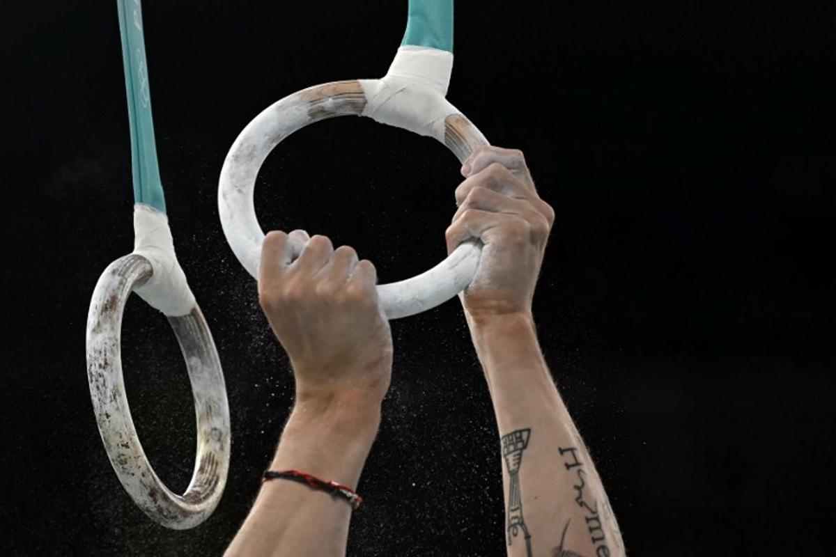 Ukraine's Illia Kovtun gets ready to compete in the rings event of the artistic gymnastics men's team final during the Paris 2024 Olympic Games at the Bercy Arena in Paris, on July 29, 2024.  Paul ELLIS / AFP