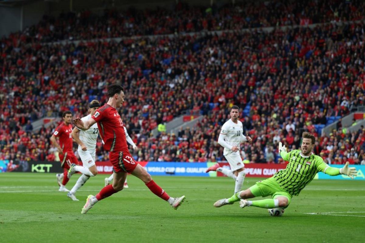 Liechtenstein's goalkeeper #01 Benjamin Buchel saves this shot from Wales' forward #13 Kieffer Moore (L) during the 2026 World Cup Group J qualifier football match between Wales and Liechtenstein, at Cardiff City Stadium, in Cardiff, on June 6, 2025.   Darren Staples / AFP
