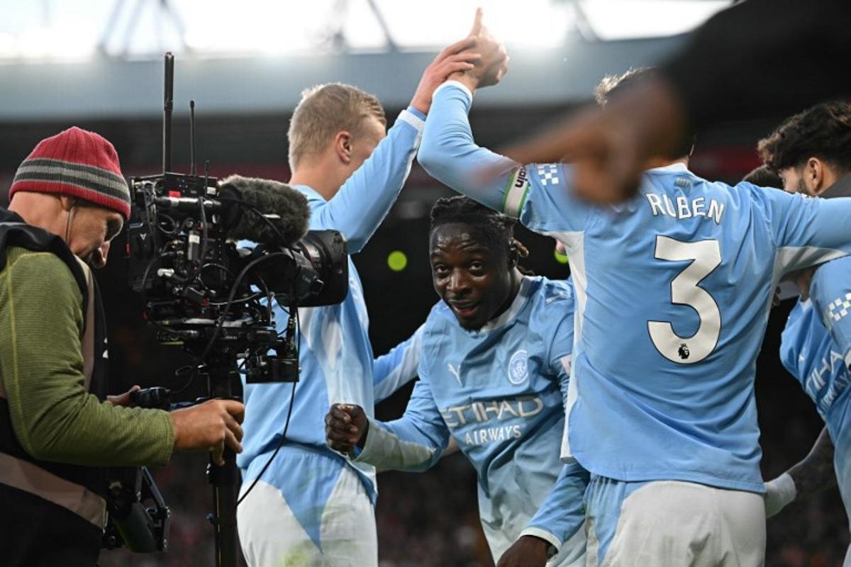 Manchester City's Belgian midfielder #11 Jeremy Doku (C) celebrates with teammates after scoring their second goal during the English Premier League football match between Liverpool and Manchester City at Anfield in Liverpool, north west England on October 11, 2026.  Paul ELLIS / AFP