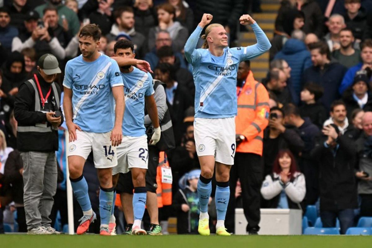 Manchester City's Norwegian striker #09 Erling Haaland (R) celebrates scoring the team's second goal during the English Premier League football match between Manchester City and Everton at the Etihad Stadium in Manchester, north west England, on October 18, 2025.  Oli SCARFF / AFP