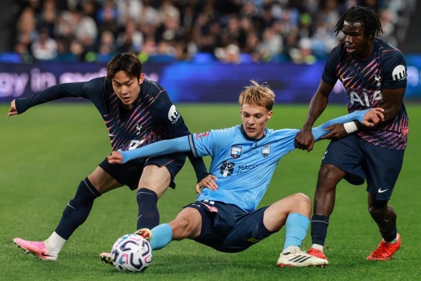 Sydney's Joseph Lacey (C) fights for the ball with Tottenham's Yang Min-hyeok (L) and Tottenham's Rio Kyerematen (R) during the Sydney Super Cup football match between Tottenham Hotspur and Sydney FC at the Allianz Stadium in Sydney on July 29, 2026.  DAVID GRAY / AFP