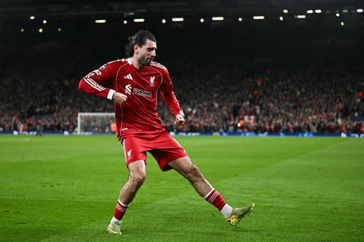 Liverpool's Hungarian midfielder #08 Dominik Szoboszlai celebrates scoring his team's first goal during the UEFA Champions League, round of 16 second leg football match between Liverpool and Galatasaray at Anfield in Liverpool, north-west England on March 18, 2026.  Paul ELLIS / AFP