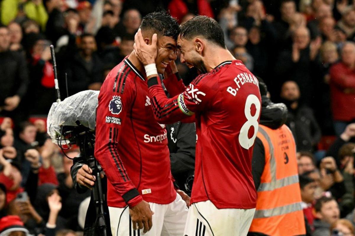 Manchester United's Brazilian midfielder #18 Casemiro celebrates scoring the team's second goal during the English Premier League football match between Manchester United and Chelsea at Old Trafford in Manchester, north west England, on September 20, 2025.  Oli SCARFF / AFP