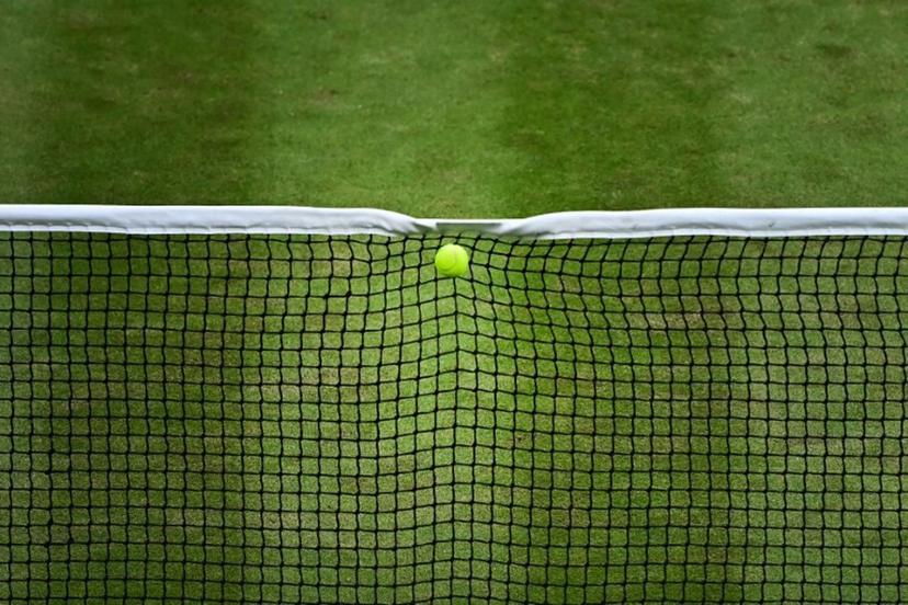 The ball served by Italy's Lorenzo Musetti hits the net during his men's singles quarter-finals tennis match against US player Taylor Fritz on the tenth day of the 2024 Wimbledon Championships at The All England Lawn Tennis and Croquet Club in Wimbledon, southwest London, on July 10, 2024.  Ben Stansall / AFP