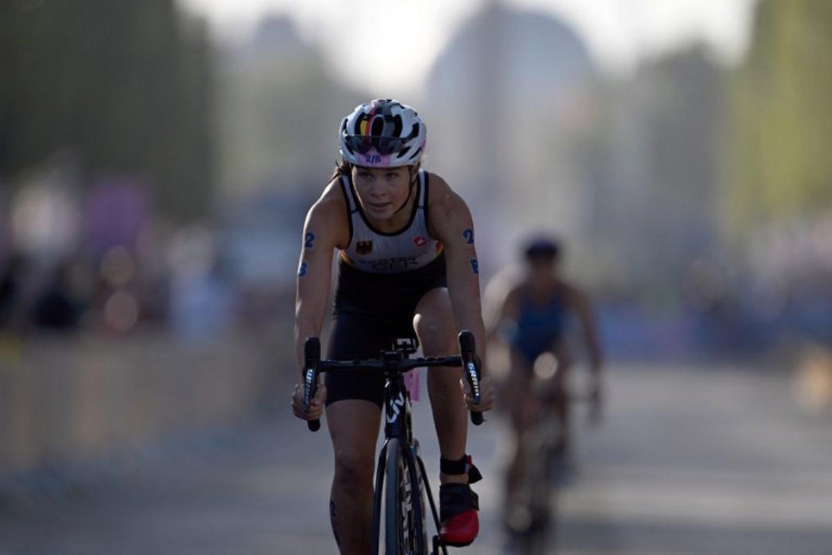 Germany's Lisa Tertsch competes in the cycling race, during the mixed's relay triathlon, at the Paris 2024 Olympic Games, in central Paris, on August 5, 2024.  Mauro PIMENTEL / AFP