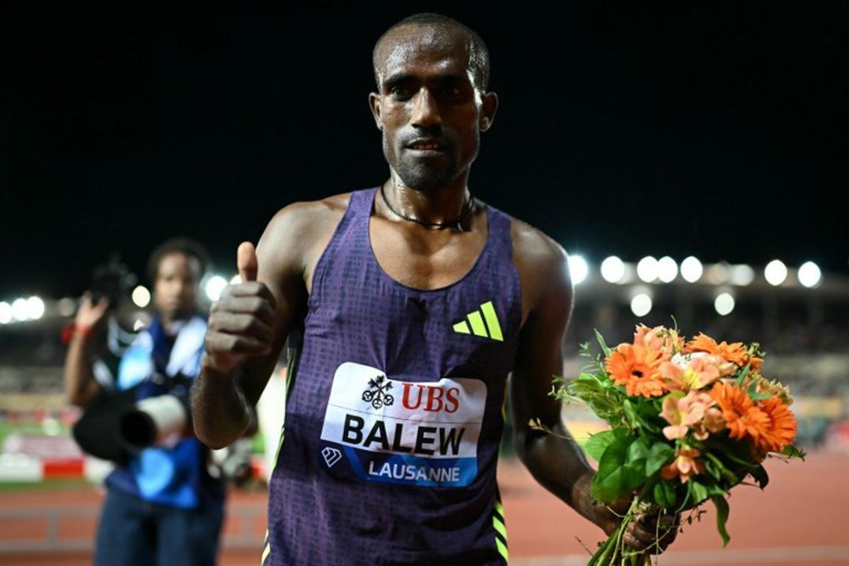 Bahrain's Birhanu Balew celebrates after winning the men's 5000m during the World Athletics Diamond League athletics meeting at the Stade Olympique de la Pontaise in Lausanne, on August 21, 2026.  Fabrice COFFRINI / AFP