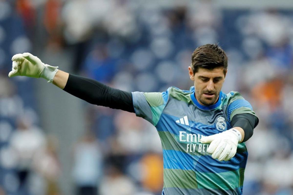 Real Madrid's Belgian goalkeeper #01 Thibaut Courtois warms up prior the Spanish league football match between Real Madrid CF and RCD Espanyol at the Santiago Bernabeu stadium in Madrid on September 20, 2025.  Oscar DEL POZO / AFP