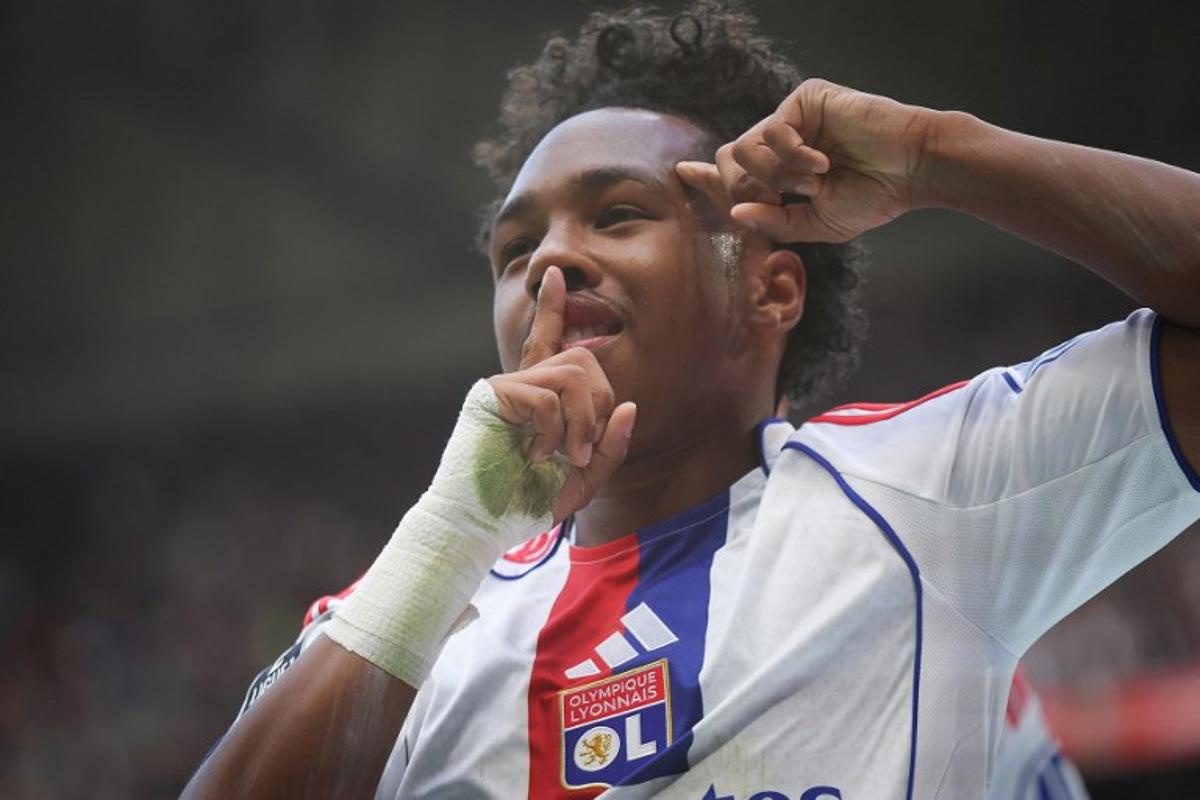 Lyon's Belgian forward #11 Malick Fofana celebrates after scoring during the French L1 football match between Olympique Lyonnais and Toulouse FC at the Parc Olympique Lyonnais in Decines-Charpieu, outside Lyon on October 5, 2025.   Alex MARTIN / AFP