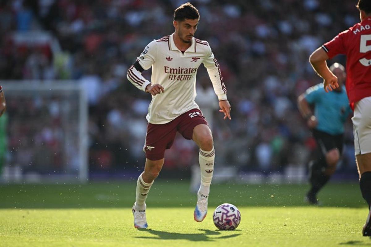 Arsenal's German midfielder #29 Kai Havertz runs with the ball during the English Premier League football match between Manchester United and Arsenal at Old Trafford in Manchester, north west England, on August 17, 2025.  Paul ELLIS / AFP
