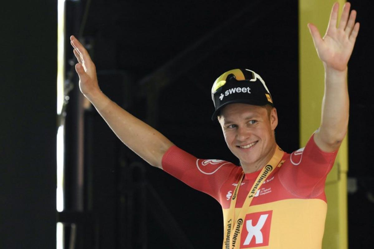 Uno-X Mobility team's Norwegian rider Jonas Abrahamsen celebrates on the podium after winning the 11th stage of the 112th edition of the Tour de France cycling race, 156.8 km starting and finishing in Toulouse, southwestern France, on July 16, 2025.  Marco BERTORELLO / AFP