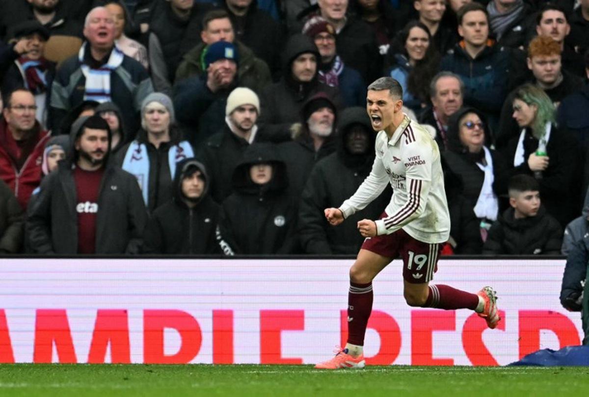 Arsenal's Belgian midfielder #19 Leandro Trossard celebrates after scoring the equalising goal during the English Premier League football match between Aston Villa and Arsenal at Villa Park in Birmingham, central England on December 6, 2025.  JUSTIN TALLIS / AFP