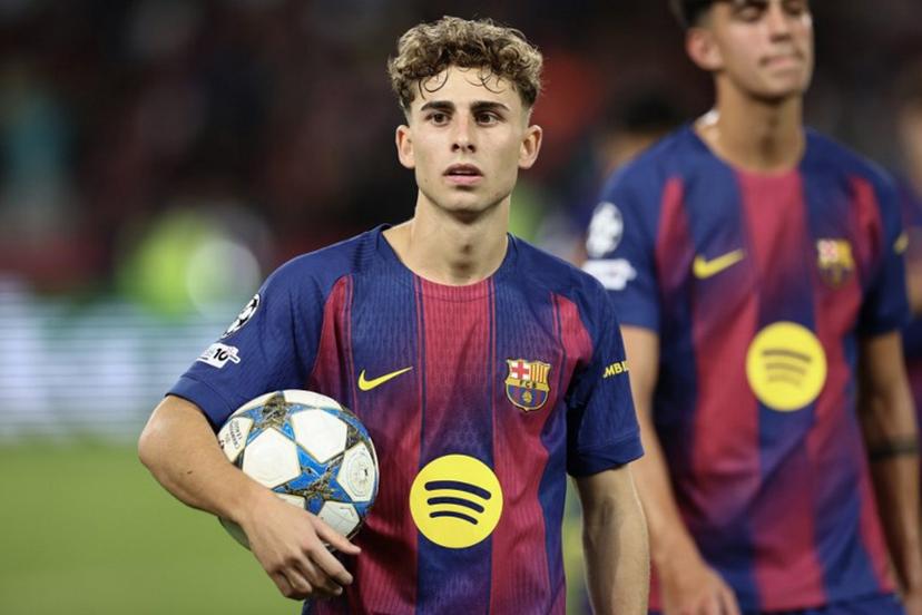 Barcelona's Spanish midfielder #16 Fermin Lopez carries the ball after scoring three goals for a hat trick in the UEFA Champions League league phase match-day 3 football match between FC Barcelona and Olympiakos FC at Estadi Olimpic Lluis Companys in Barcelona on October 21, 2025. Barcelona won 6-1.  Josep LAGO / AFP