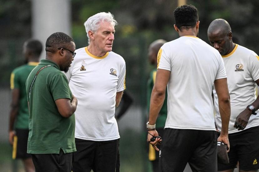 South Africa's headcoach Hugo Broos (C) speaks to South Africa's players as they attend a training session at the Lycee Classique stadium in Abidjan on February 9, 2024, on the eve of the 2024 African Cup of Nations (CAN) football match between South Africa and DR Congo for third place.  Sia KAMBOU / AFP
