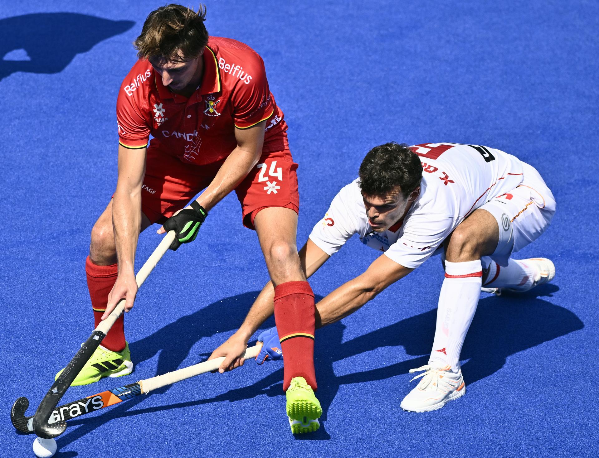 Belgium's Antoine Kina and Spanish Xavier Gispert pictured during a hockey game between Spain and the Belgian national team Red Lions, match 3/3 in the pool stage of the 2025 men's European championships, Tuesday 12 August 2025 in Monchengladbach, Germany. BELGA PHOTO ERIC LALMAND