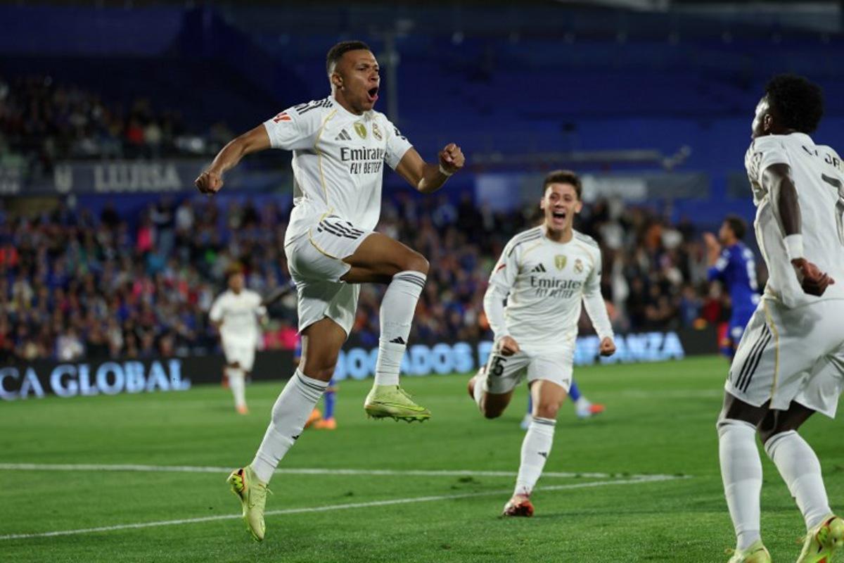 Real Madrid's French forward #10 Kylian Mbappe celebrates scoring his team's first goal during the Spanish league football match between Getafe CF and Real Madrid CF at Coliseum Alfonso Perez Stadium in Getafe on October 19, 2025.  Thomas COEX / AFP