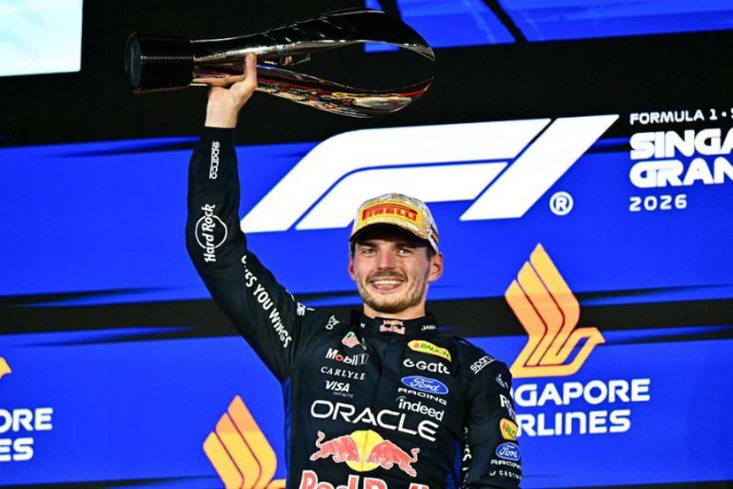 Winner Red Bull Racing's Dutch driver Max Verstappen lifts his trophy as he celebrates on the podium after the Formula One Singapore Grand Prix at the Marina Bay Street Circuit in Singapore on October 11, 2026.  Lillian SUWANRUMPHA / AFP