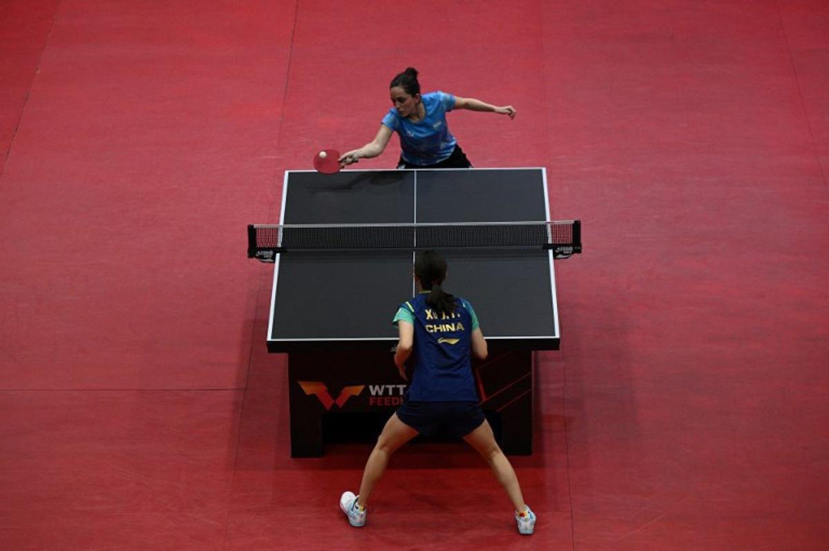 Argentina's Ana Codina (Top) hits a return to China's Xu Jaiyi during their women's singles final table teennis match of the World Table Tennis (WTT) Feeder Series at Popper & Lopez Sports Center in Caracas on November 3, 2024.  Federico PARRA / AFP