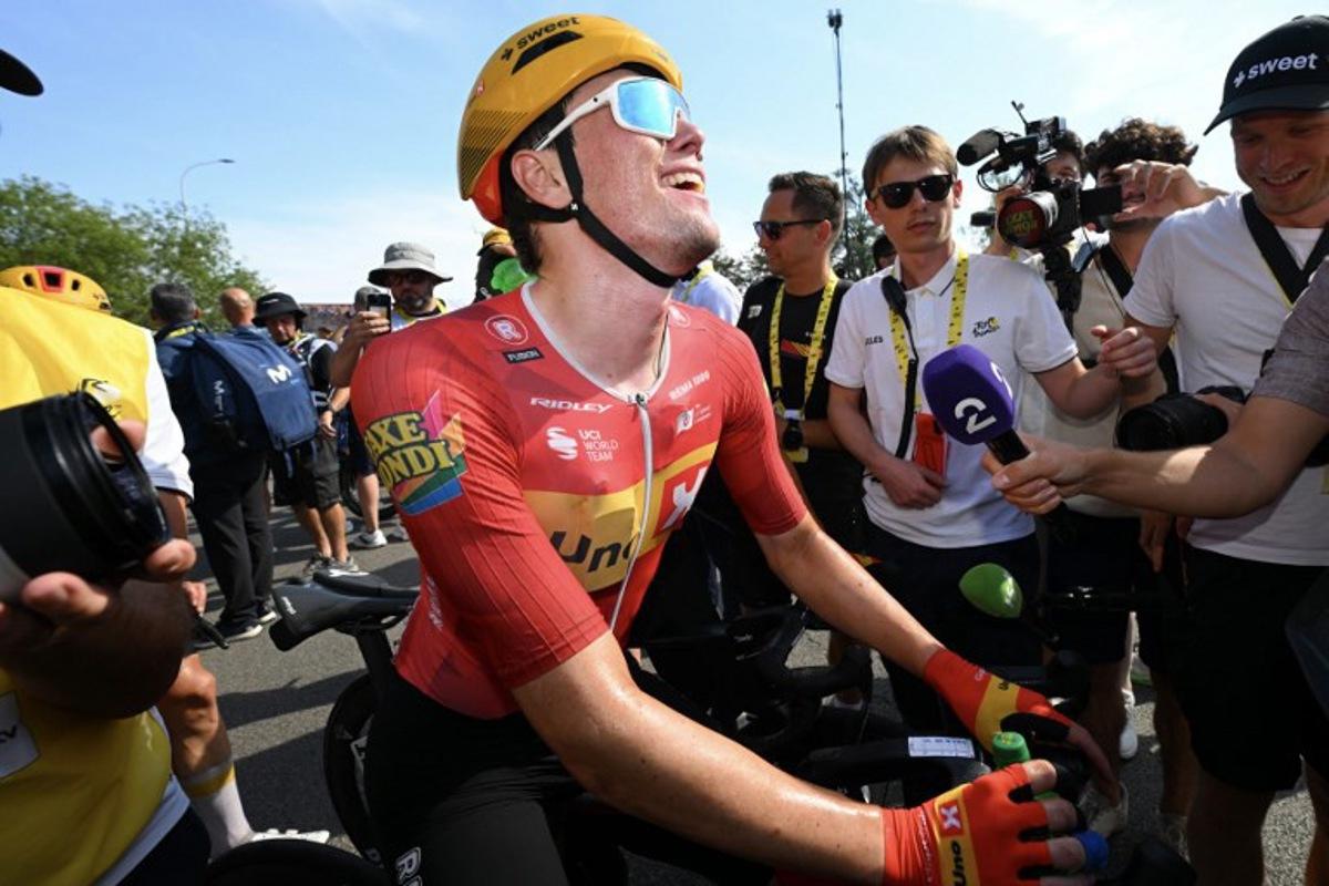 Uno-X Mobility team's Norwegian rider Soren Waerenskjold celebrates after winning the 11th stage of the 113th edition of the Tour de France cycling race, 161,3 km between Vichy and Nevers in central France, on July 15, 2026.  Tim De Waele / POOL / AFP