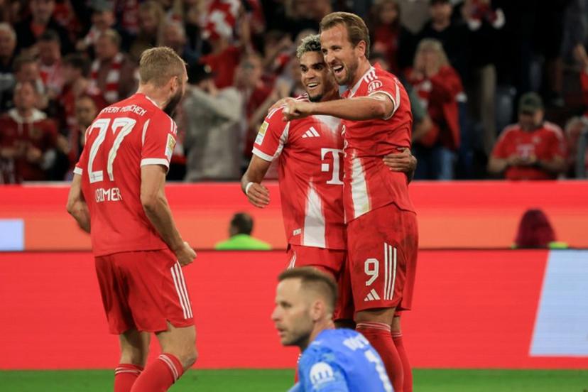 Bayern Munich's English forward #09 Harry Kane (R) celebrate with Bayern Munich's Colombian forward #14 Luis Diaz (2R) and Bayern Munich's Austrian midfielder #27 Konrad Laimer after scoring his team's fourth goal as Leipzig's Hungarian goalkeeper #01 Peter Gulacsi (front bottom) looks on during the German first division Bundesliga football match between FC Bayern Munich and RB Leipzig in Munich, southern Germany, on August 22, 2025.  Karl-Josef Hildenbrand / AFP