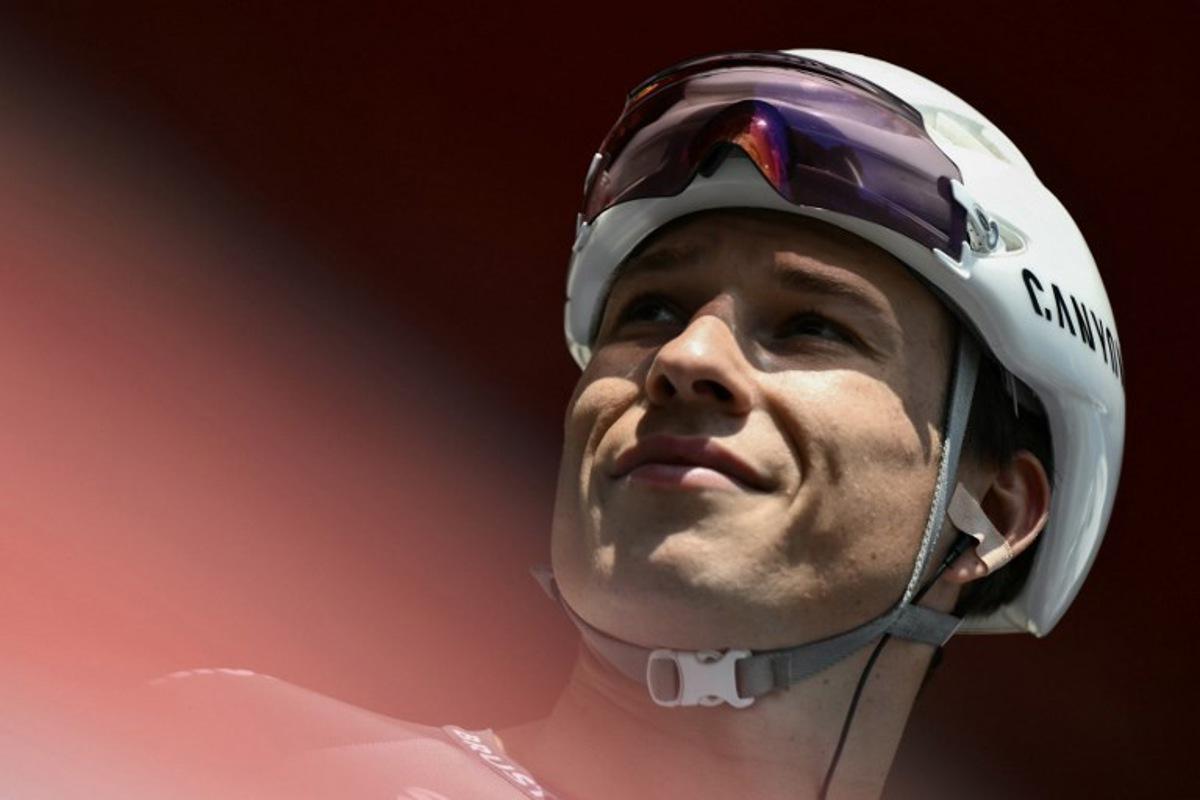 Team Alpecin's Belgian rider Jasper Philipsen is presented on stage before the start of the Vuelta a Espana, a 183 km race between Torino - Reggia di Venaria and Novara, in Italy's Piemonte region, on August 23, 2025.    Marco BERTORELLO / AFP
