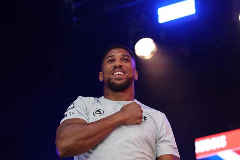 Britain's Anthony Joshua gestures as he arrives on stage for a public weigh-in in Trafalgar Square on September 20, 2024 on the eve of a heavyweight boxing match for the IBF world title in London. Daniel Dubois says he has to justify his status as IBF world heavyweight champion by showing he is the coming force in British boxing against Anthony Joshua at a sold-out Wembley on Saturday. The pair will battle it out in front of a reported post-war British record crowd of 96,000. Dubois won the interim IBF title in June and was elevated to world champion status when Oleksandr Usyk vacated.  Adrian Dennis / AFP
