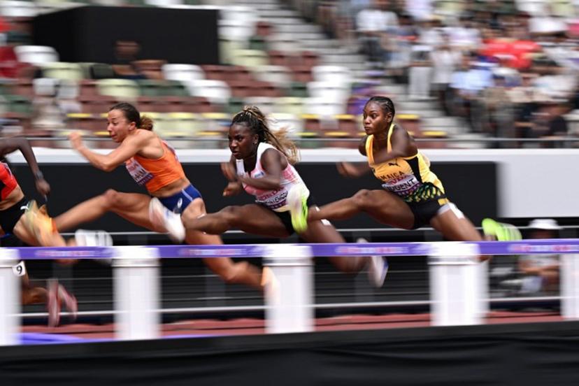 (L-R) Netherlands' athlete Maayke Tjin-A-Lim, Belgium's athlete Yanla Ndjip-Nyemeck, and Jamaica's athlete Ackera Nugent compete in the women's 100m hurdles heats during the World Athletics Championships in Tokyo on September 14, 2025.  Kirill KUDRYAVTSEV / AFP