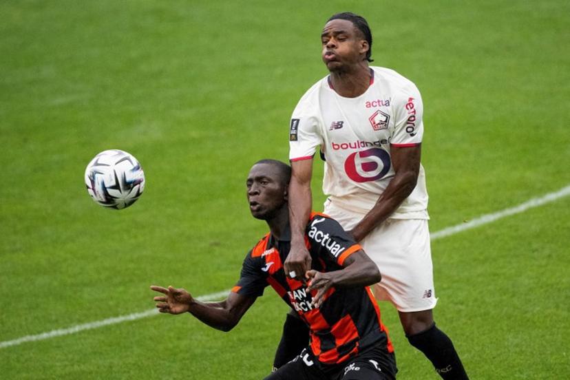 Lorient's Senegalese forward #28 Sambou Soumano (C) fights for the ball with Lille's Belgian defender #03 Nathan Ngoy (R) during the French L1 football match between FC Lorient and lille OSC at Yves-Allainmat stadium in Lorient, western France on August 30, 2025.   Loic VENANCE / AFP