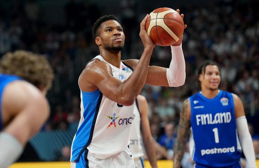 Greece's small forward #34 Giannis Antetokounmpo (C) holds the ball during the FIBA EuroBasket 2025 third place basketball match between Greece and Finland in Riga, Latvia, on September 14, 2025.  Gints Ivuskans / AFP