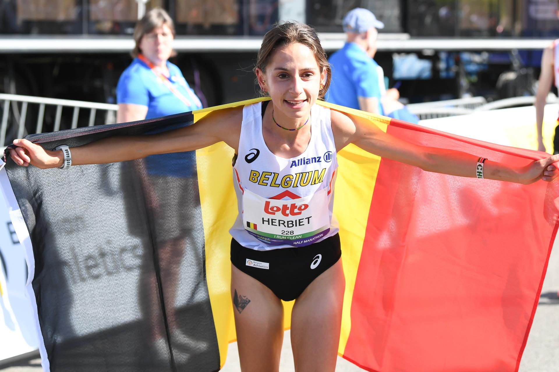 Belgian Chloe Herbiet celebrates after winning the half marathon race at European Running Championships, in Leuven, Saturday 12 April 2025. BELGA PHOTO JILL DELSAUX