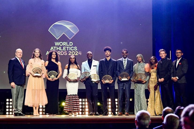 (From L) Prince Albert II of Monaco, the laureates holding their awards, Ukrainian high jumper Yaroslava Mahuchikh (Women's field athlete of the year), US hurdler Sydney McLaughlin-Levrone (Women's track athlete of the year), Ethiopian athlete Sembo Almayew (Women's rising star), Botswanan sprinter Letsile Tebogo (Men's track athlete of the year), Italian high jumper Mattia Furlani (Men's rising star), Ethiopian long-distance runner Tamirat Tola (Men's out of stadium athlete of the year) and Dutch middle and long-distance runner Sifan Hassan (Women's out of stadium athlete of the year) and World Atheltics President Sebastian Coe and Ecuadorian racewalker Brian Pintado pose on stage  during the World Athletics Awards 2024 in Monaco on December 1, 2024.  FREDERIC DIDES / AFP