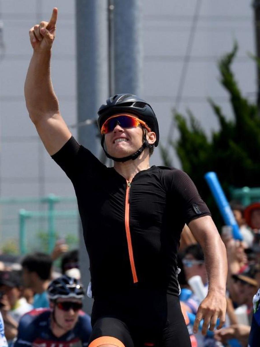 Estonian rider Martin Laas of US team Illuminate celebrates his victory after crossing the finish line of the Tour of Japan cycling road race final stage in Tokyo on May 27, 2018.  Toshifumi KITAMURA / AFP