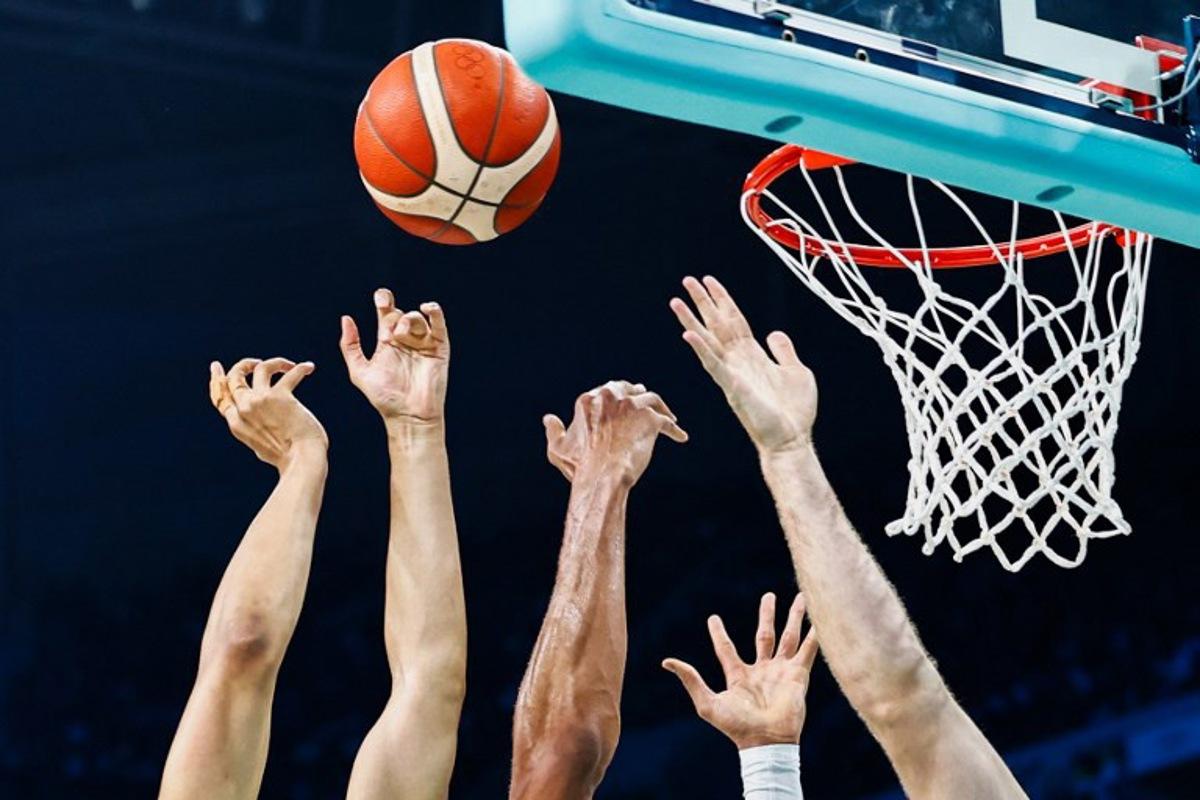 (From L) The hands of Australia's #11 Dante Exum, Greece's #34 Giannis Antetokounmpo and Australia's #22 Will Magnay go for a rebound in the men's preliminary round group A basketball match between Australia and Greece during the Paris 2024 Olympic Games at the Pierre-Mauroy stadium in Villeneuve-d'Ascq, northern France, on August 2, 2024.  Sameer Al-Doumy / AFP