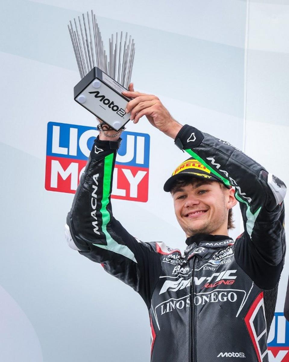 Second-placed Fantic Racing Team's Belgiums Moto2 rider Barry Baltus celebrates on the podium with his trophy after the German Moto2 Grand Prix at the Sachsenring racing circuit, in Hohenstein-Ernstthal near Chemnitz, eastern Germany on July 13, 2025.  Ronny Hartmann / AFP