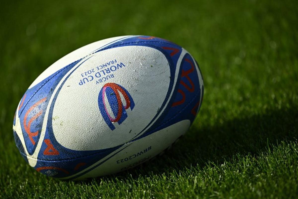 This photograph taken on October 10, 2023, shows an official Rugby World Cup ball displayed on the pitch during a training session at the French National Institute of Sport, Expertise, and Performance (INSEP), in Paris, as part of the France 2023 Rugby World Cup. New Zealand will meet Ireland for the quarter final 2 match at the Stade de France in Saint-Denis, on the outskirts of Paris, on October 14, 2023. JULIEN DE ROSA / AFP